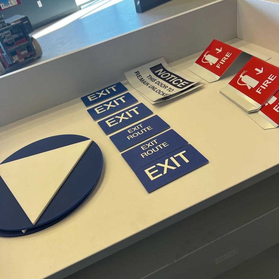 ADA exit and fire safety signs for an office building in San Jose